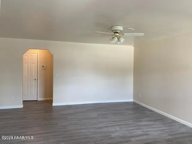 a view of a room with wooden floor