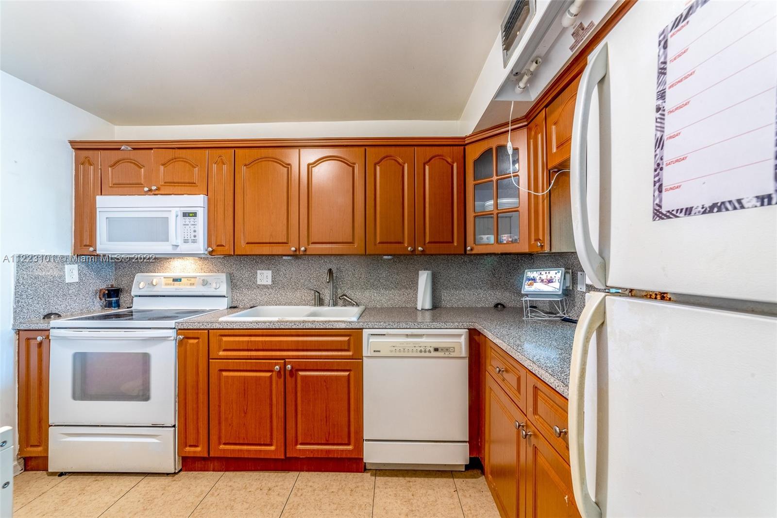 3490 Foxcroft Road, Unit B103 Miramar, FL 33025 - Photo 11 of 37 a kitchen with stainless steel appliances granite countertop a stove a sink and a microwave