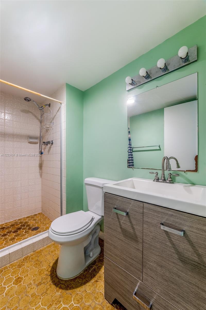 3490 Foxcroft Road, Unit B103 Miramar, FL 33025 - Photo 20 of 37 a bathroom with a granite countertop sink a toilet and a mirror