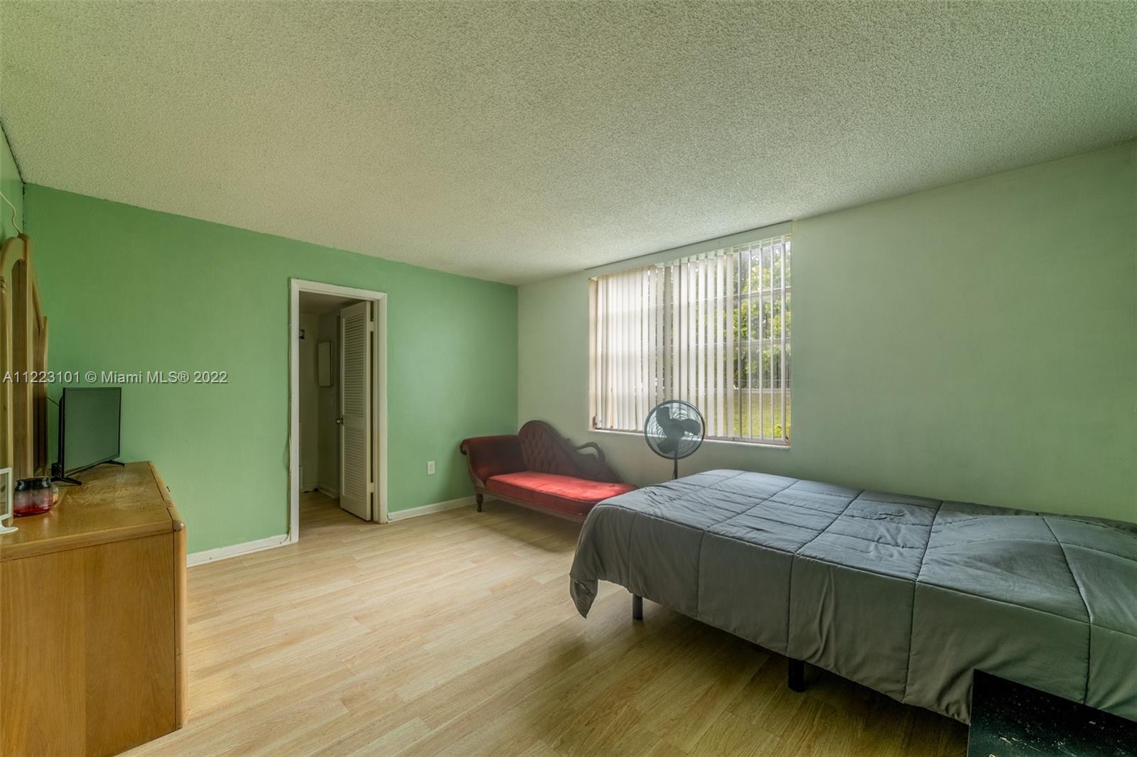 3490 Foxcroft Road, Unit B103 Miramar, FL 33025 - Photo 26 of 37 a bedroom with a bed and a window
