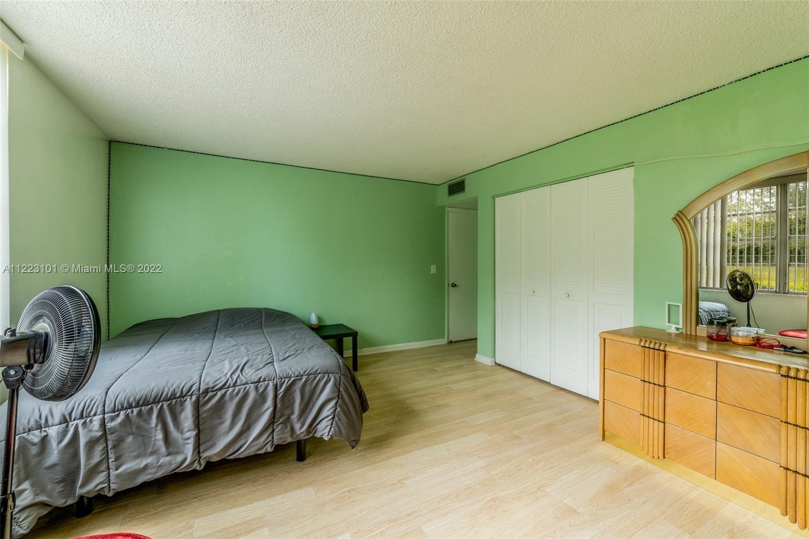 3490 Foxcroft Road, Unit B103 Miramar, FL 33025 - Photo 29 of 37 a bedroom with a bed and a table