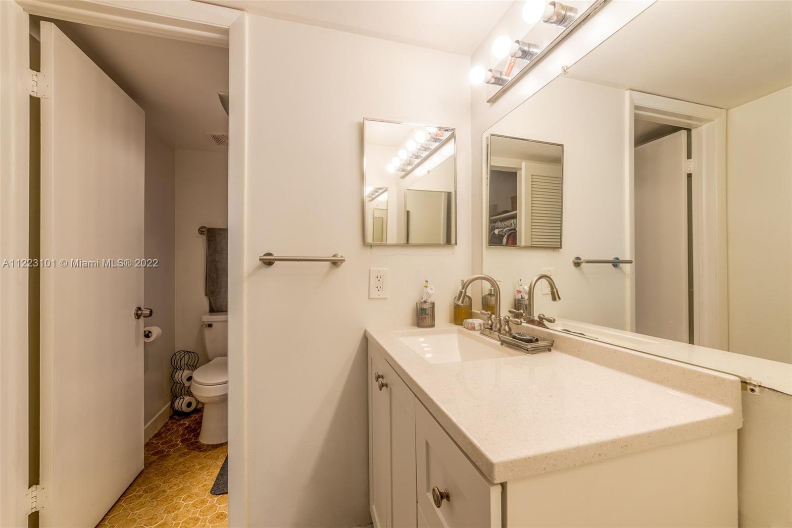 3490 Foxcroft Road, Unit B103 Miramar, FL 33025 - Photo 32 of 37 a bathroom with a sink vanity and a mirror
