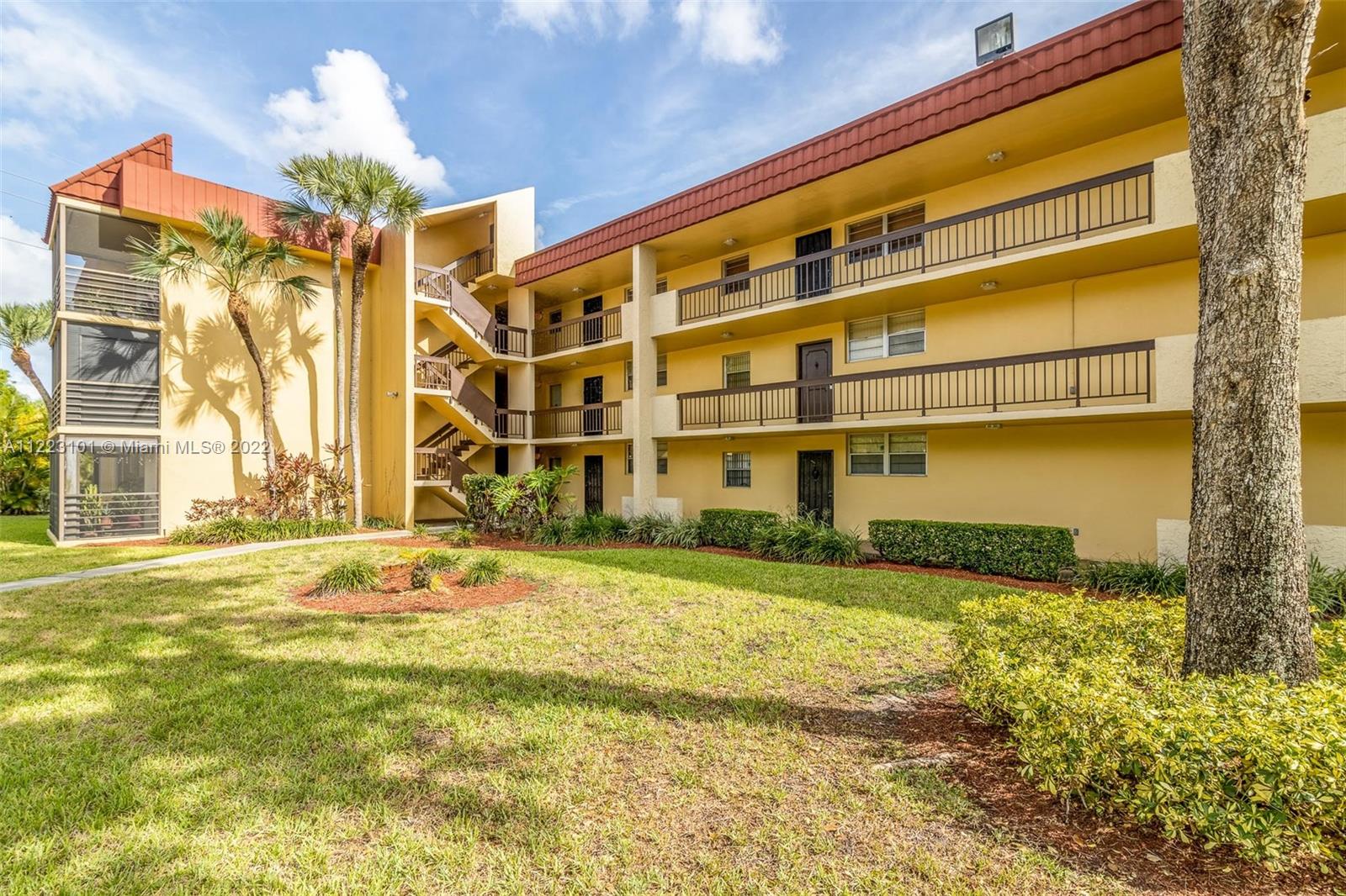 3490 Foxcroft Road, Unit B103 Miramar, FL 33025 - Photo 35 of 37 a front view of a building with a big yard