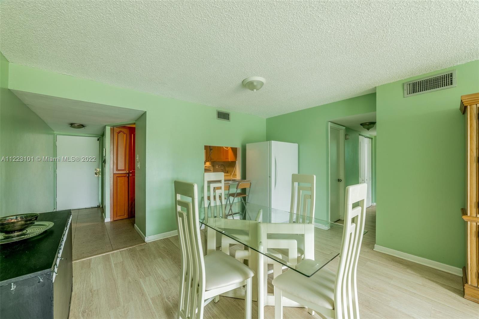3490 Foxcroft Road, Unit B103 Miramar, FL 33025 - Photo 5 of 37 a dining room with furniture and a kitchen