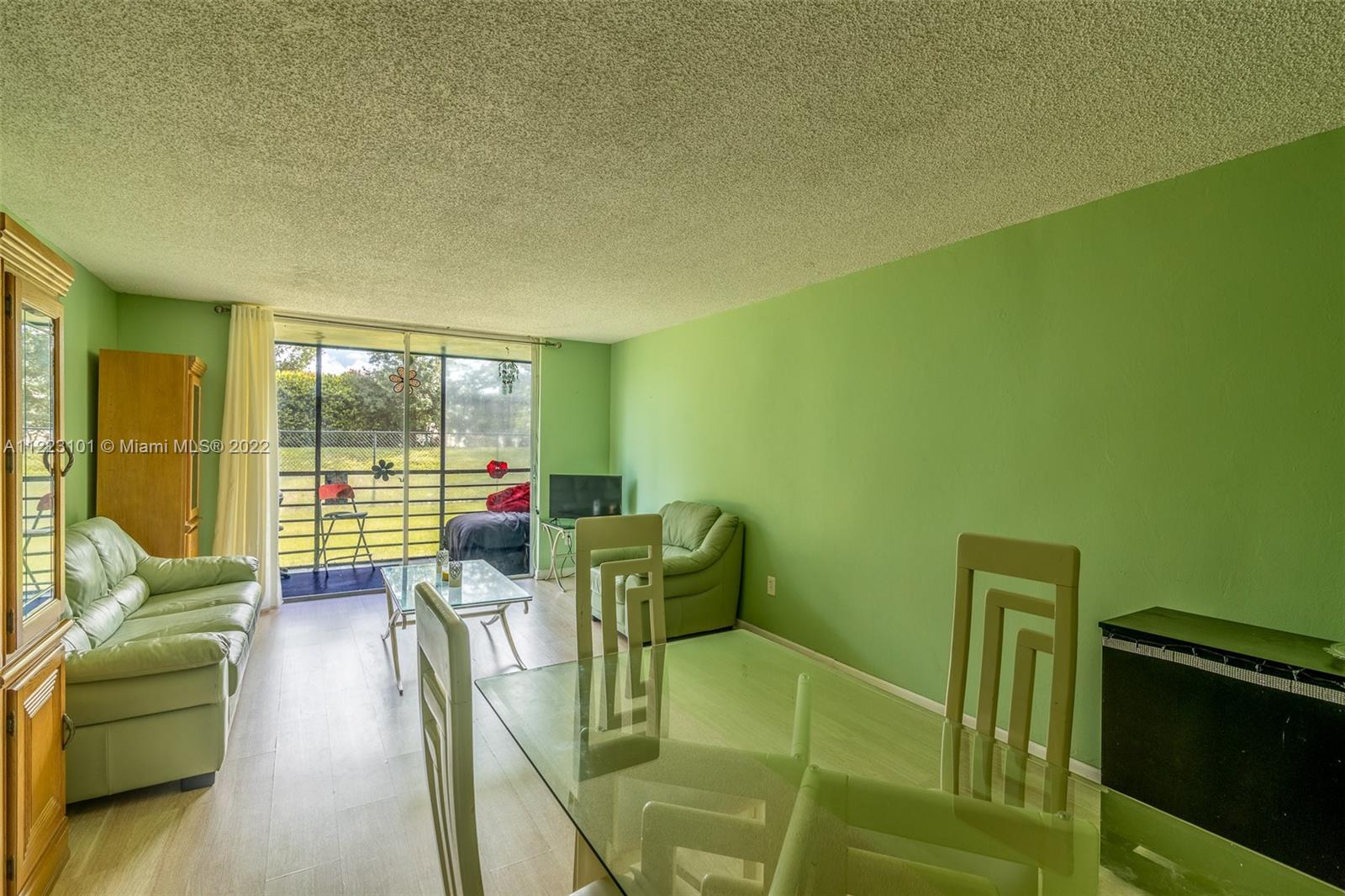 3490 Foxcroft Road, Unit B103 Miramar, FL 33025 - Photo 8 of 37 a living room with furniture and a large window