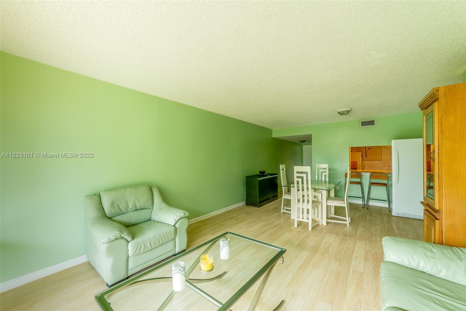 3490 Foxcroft Road, Unit B103 Miramar, FL 33025 - Photo 10 of 37 a living room with furniture and a flat screen tv