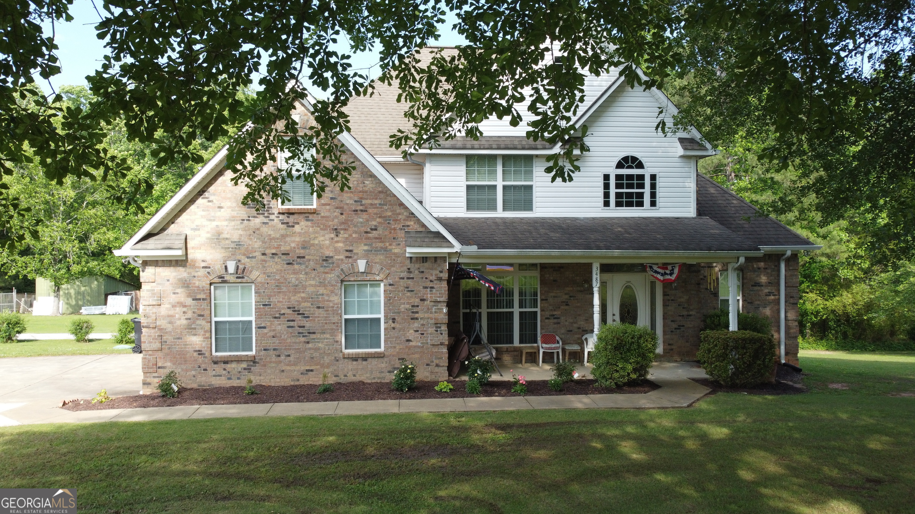 3487 Kellogg Creek Road Acworth, GA 30102 - Photo 15 of 16 a view of a yard in front of a house with plants and large tree