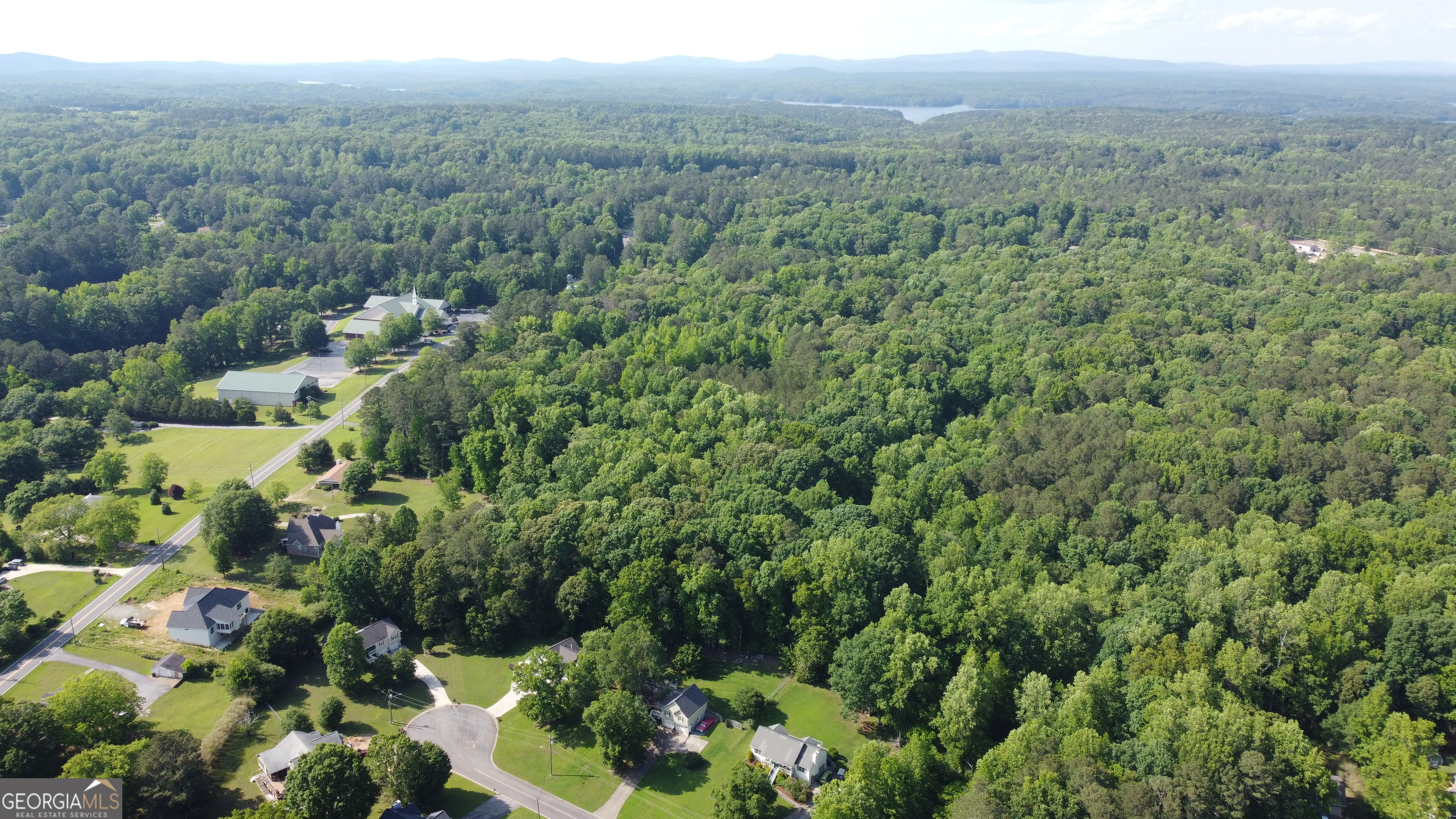 3487 Kellogg Creek Road Acworth, GA 30102 - Photo 6 of 16 an aerial view of a houses with a lush green forest