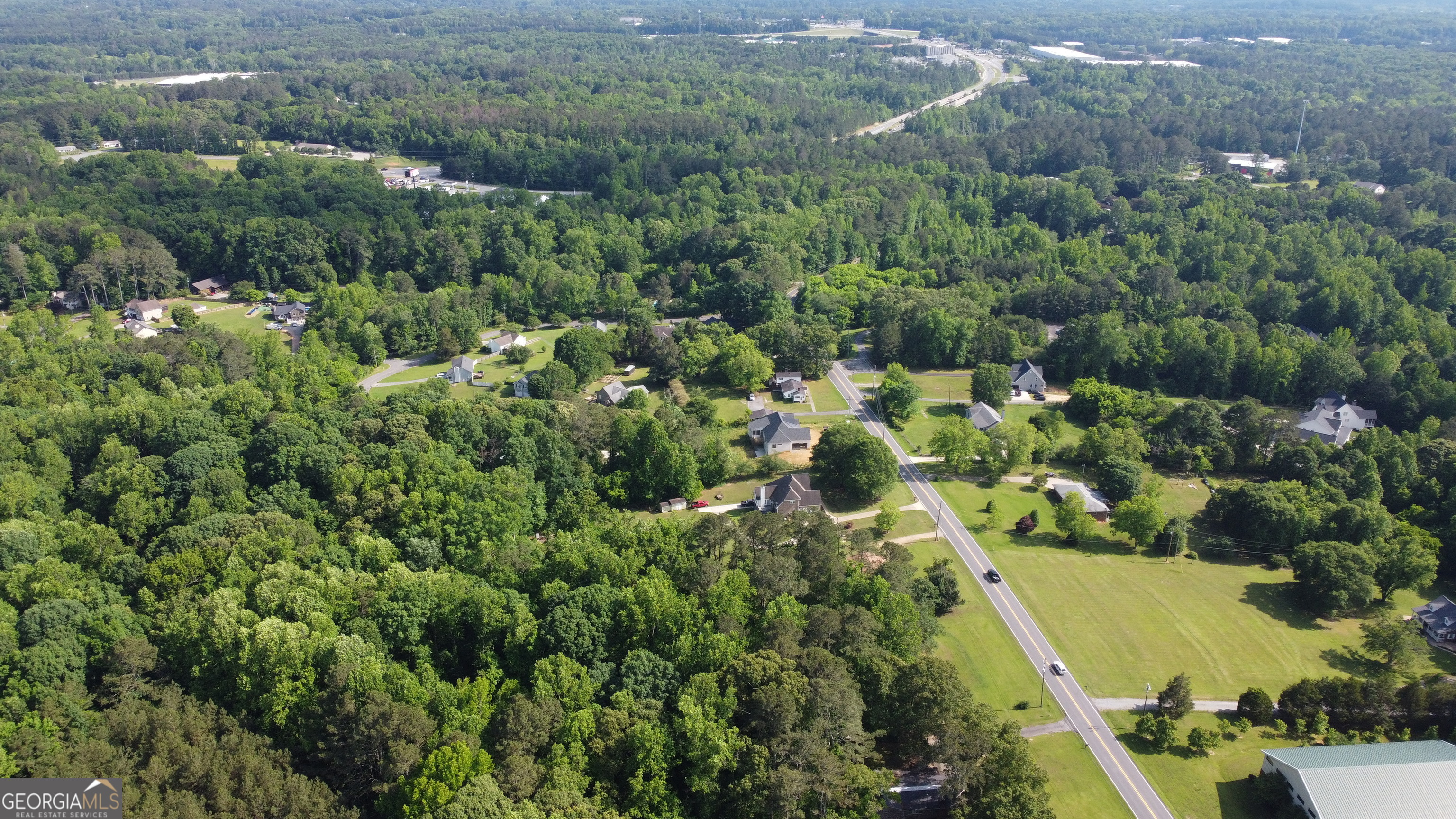 3487 Kellogg Creek Road Acworth, GA 30102 - Photo 8 of 16 an aerial view of residential houses with outdoor space and trees