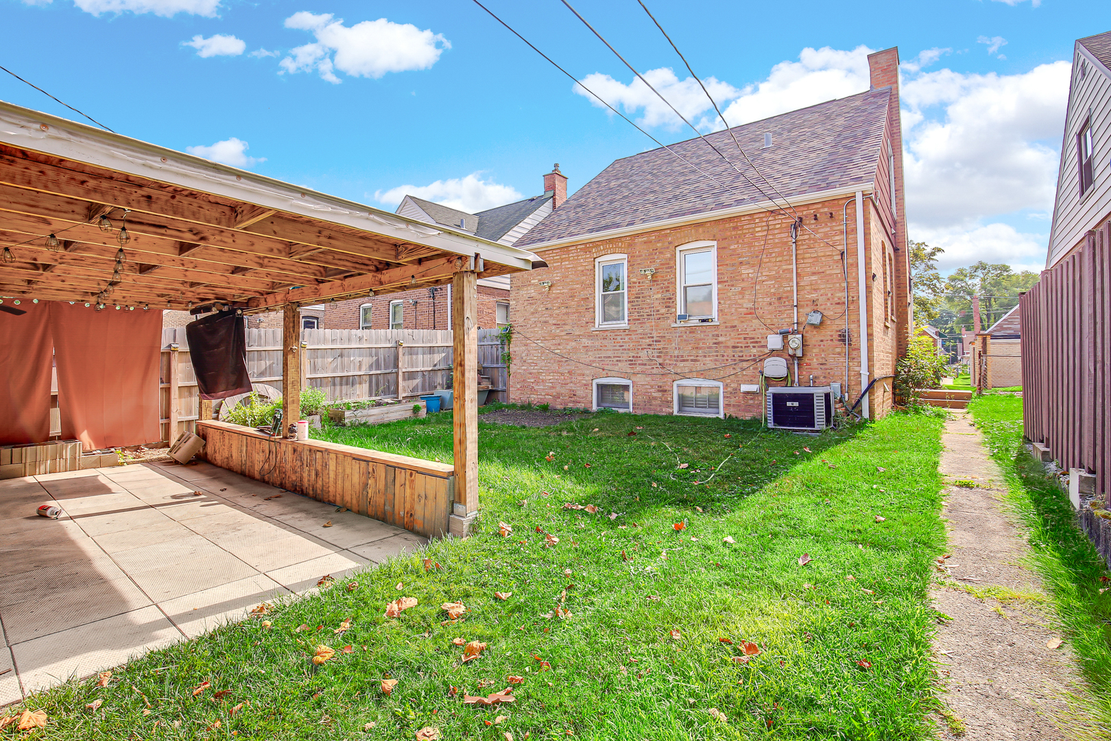 11312 South Avenue H Chicago, IL 60617 - Photo 21 of 21 a front view of a house with a yard table and chairs