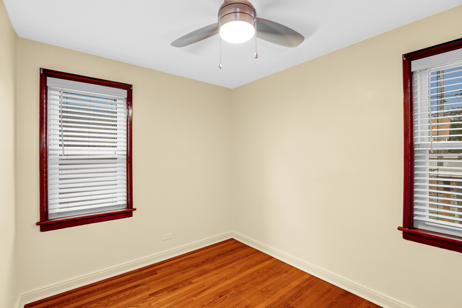 11312 South Avenue H Chicago, IL 60617 - Photo 10 of 21 a view of empty room with wooden floor and fan