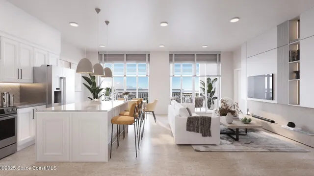 a living room with stainless steel appliances granite countertop furniture and a counter space