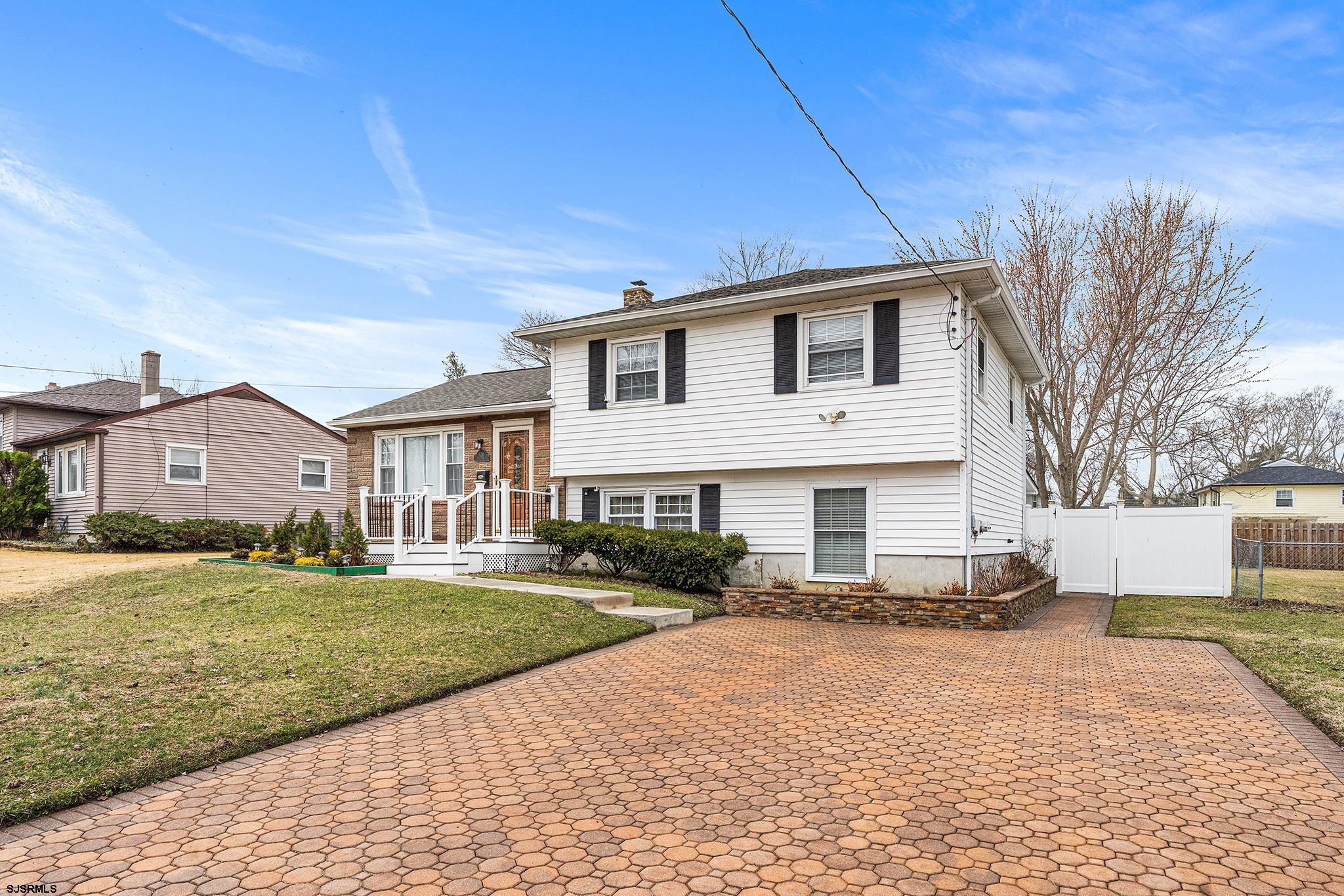 128 Devon Road Somers Point, NJ 08244 - Photo 1 of 40 a front view of a house with a yard