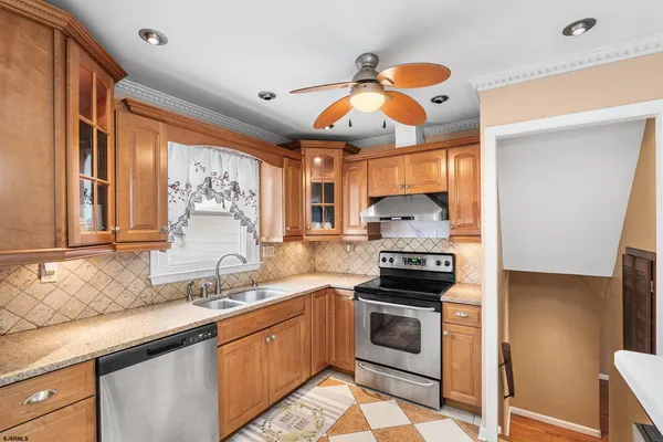 a kitchen with stainless steel appliances granite countertop a stove and a sink