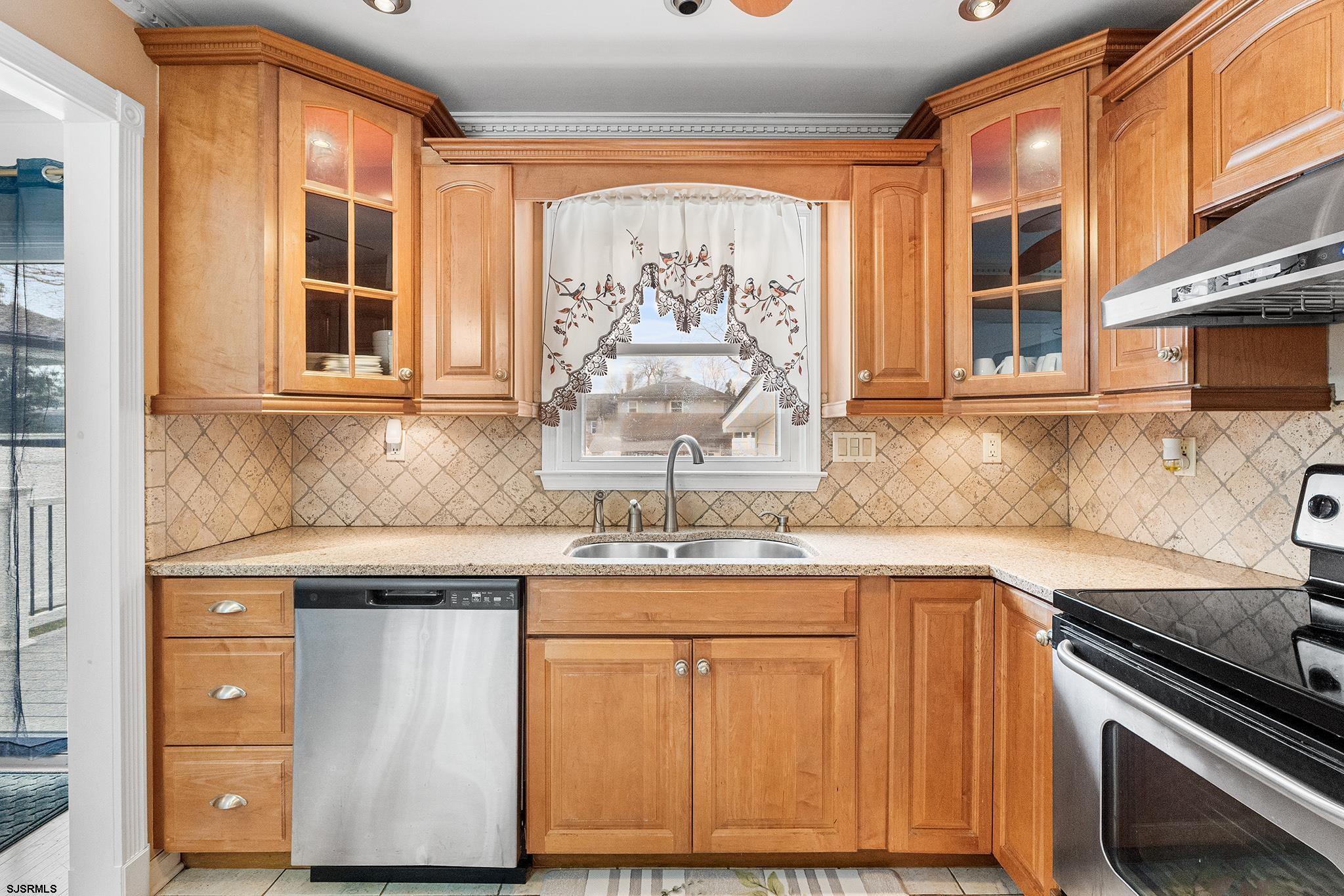 128 Devon Road Somers Point, NJ 08244 - Photo 13 of 40 a kitchen with stainless steel appliances granite countertop a stove and a microwave