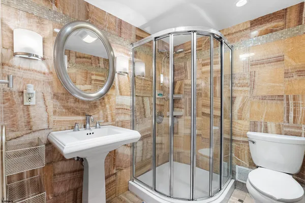 a bathroom with a sink toilet and shower