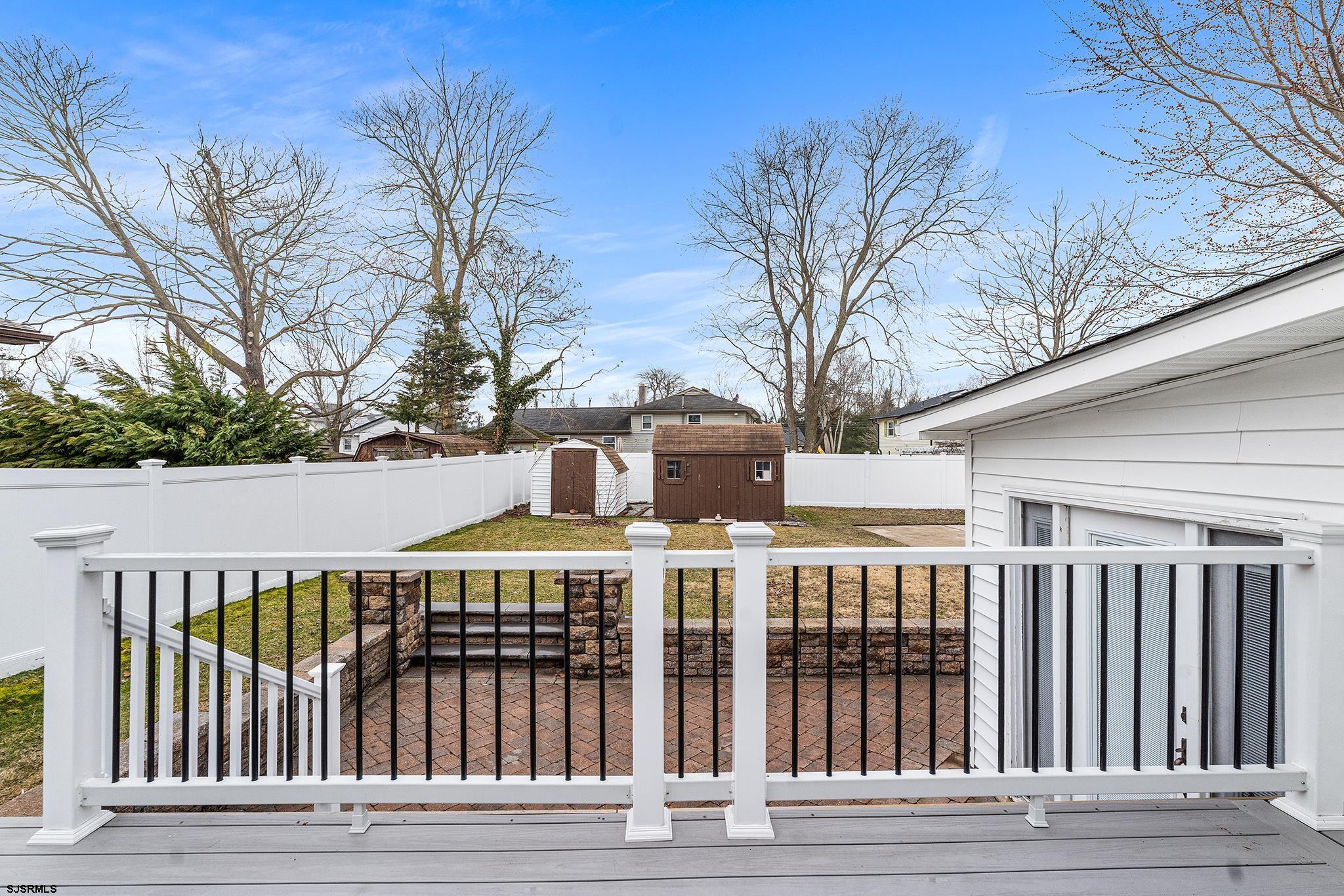 128 Devon Road Somers Point, NJ 08244 - Photo 31 of 40 a view of a large building with a wooden fence