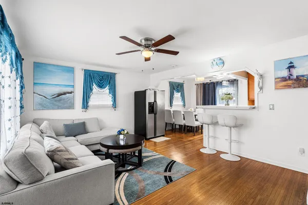 a living room with furniture and wooden floor