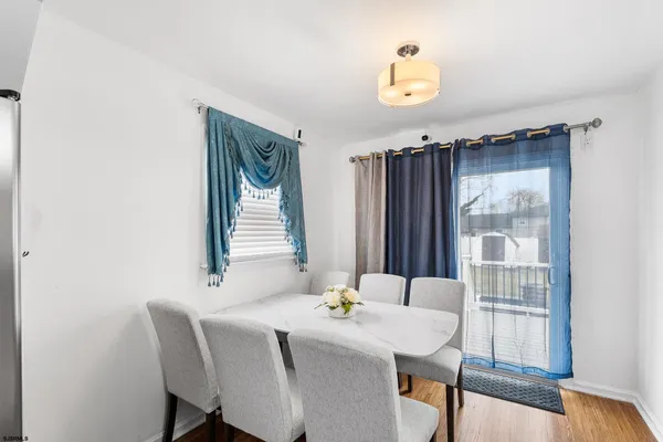 a dining room with furniture and window