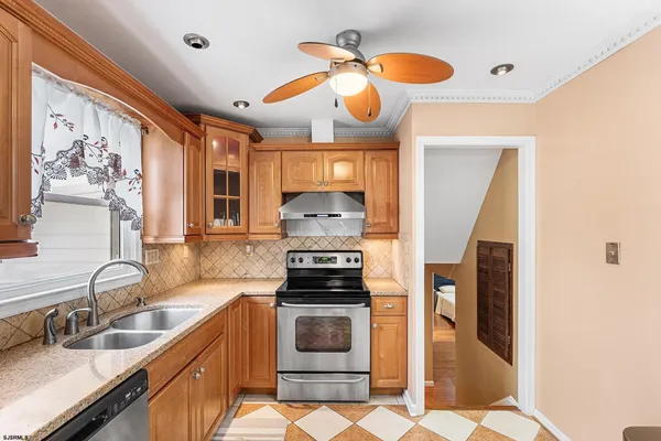 a kitchen with granite countertop a stove and a sink