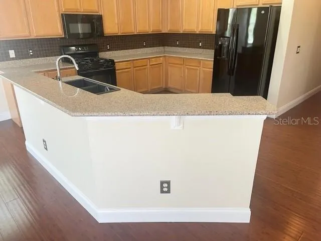 an empty room with wooden floor and a window