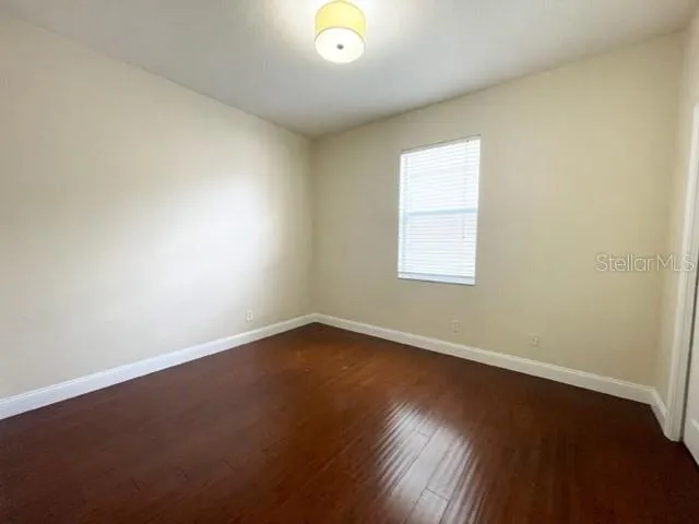 a view of a house with a yard and potted plants