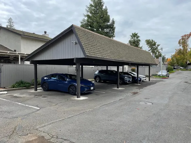 a view of a patio with table and chairs under an umbrella