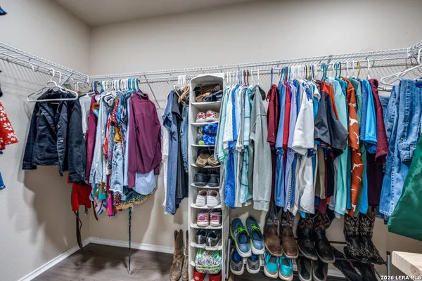 a view of walk in closet with clothes