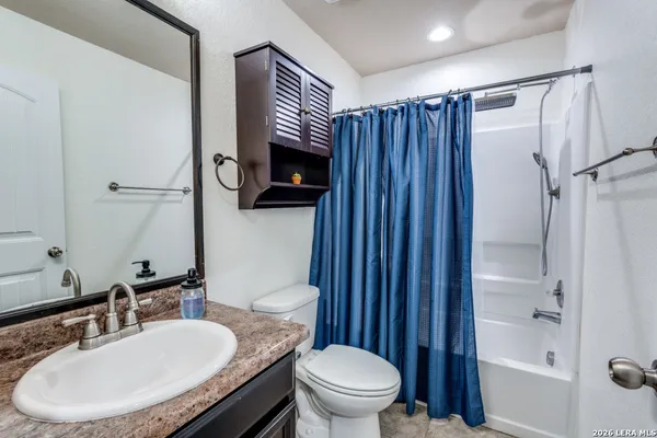 a bathroom with a toilet a sink and a mirror