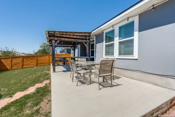 a view of a patio with table and chairs with a yard