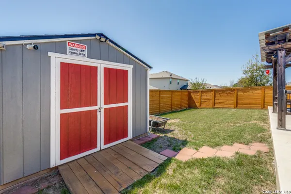 a view of a backyard with a door and a yard