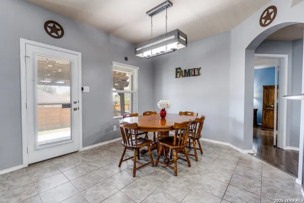 a view of a dining room with furniture and a chandelier
