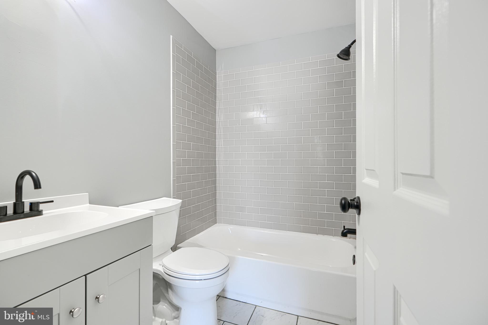 213 Colgate Avenue Baltimore, MD 21222 - Photo 18 of 24 a bathroom with a sink a toilet and shower