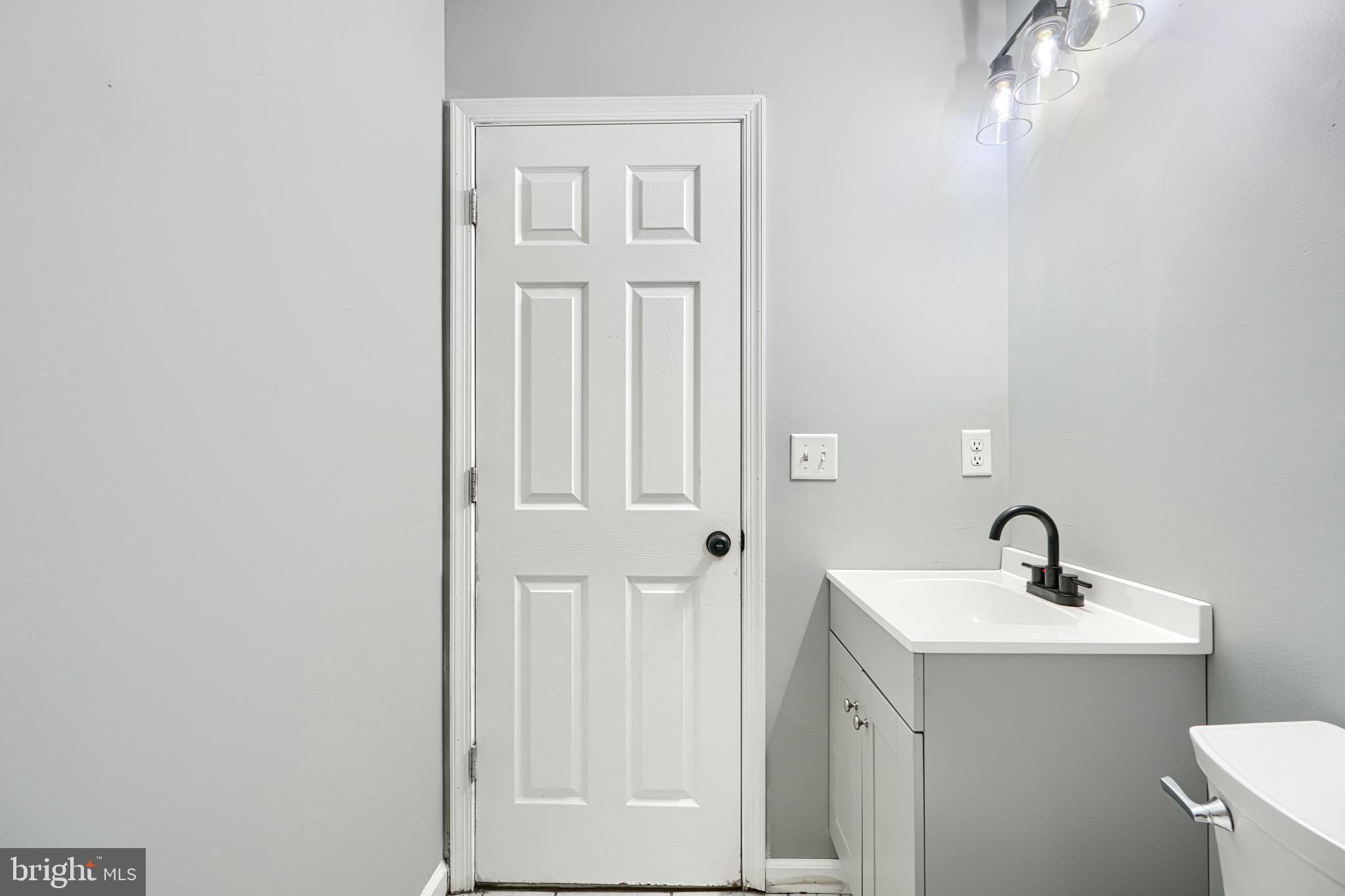 213 Colgate Avenue Baltimore, MD 21222 - Photo 20 of 24 a bathroom with a sink and a mirror