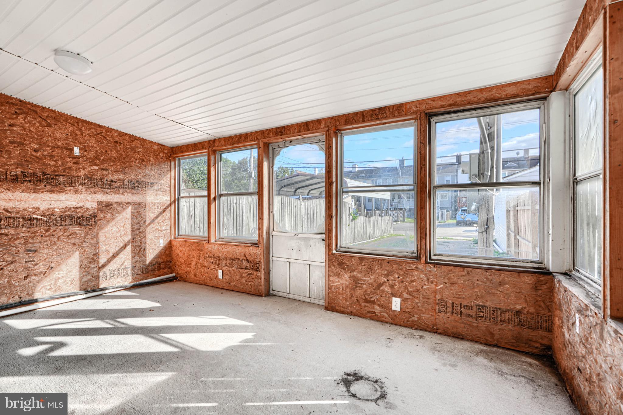 213 Colgate Avenue Baltimore, MD 21222 - Photo 22 of 24 a living room filled with furniture and large windows