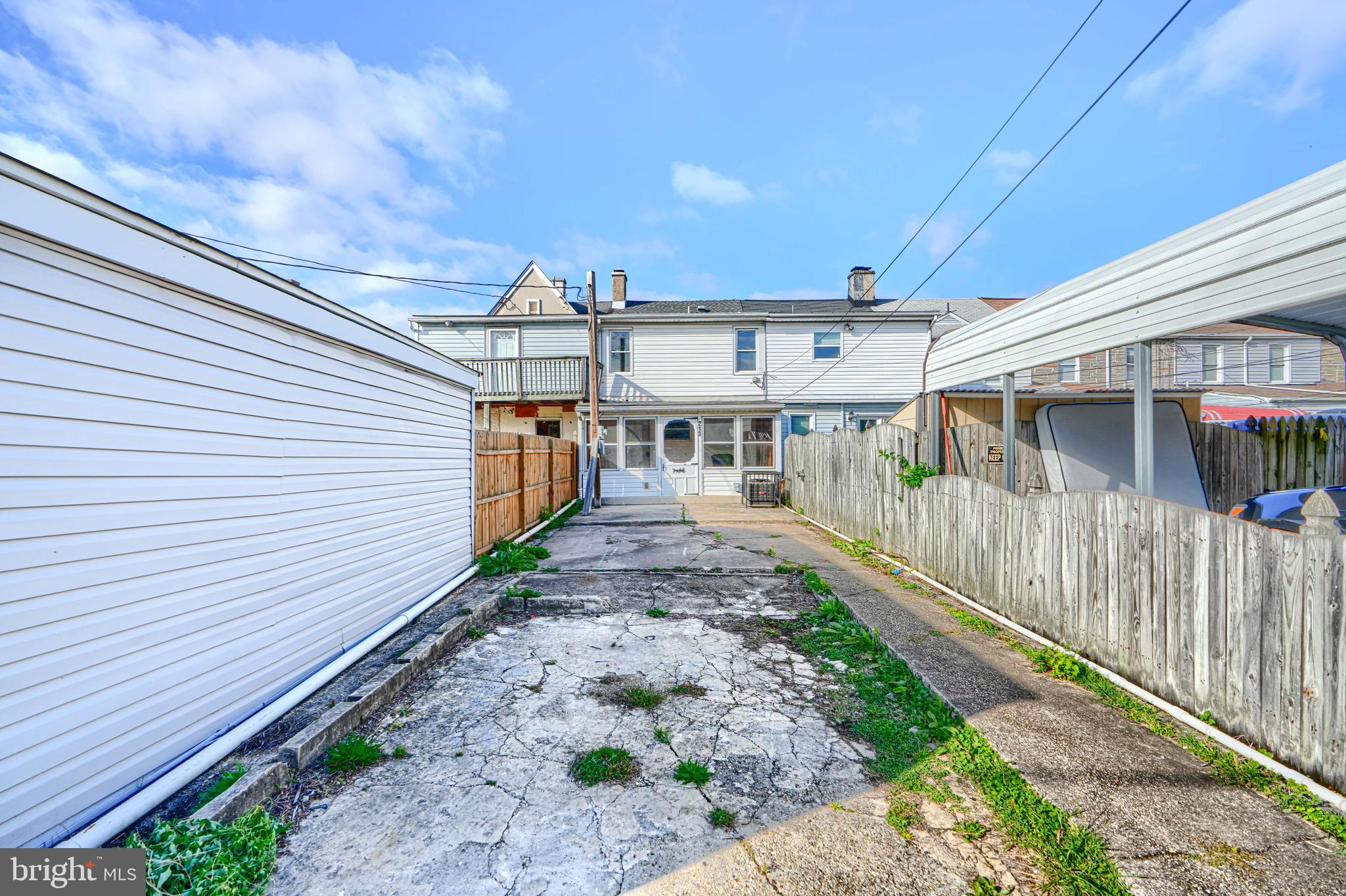 213 Colgate Avenue Baltimore, MD 21222 - Photo 24 of 24 a view of a house with a small yard and wooden fence