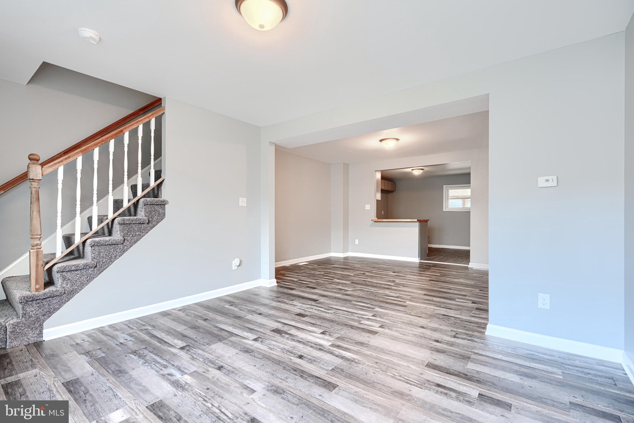 213 Colgate Avenue Baltimore, MD 21222 - Photo 4 of 24 a view of a hallway with wooden floor