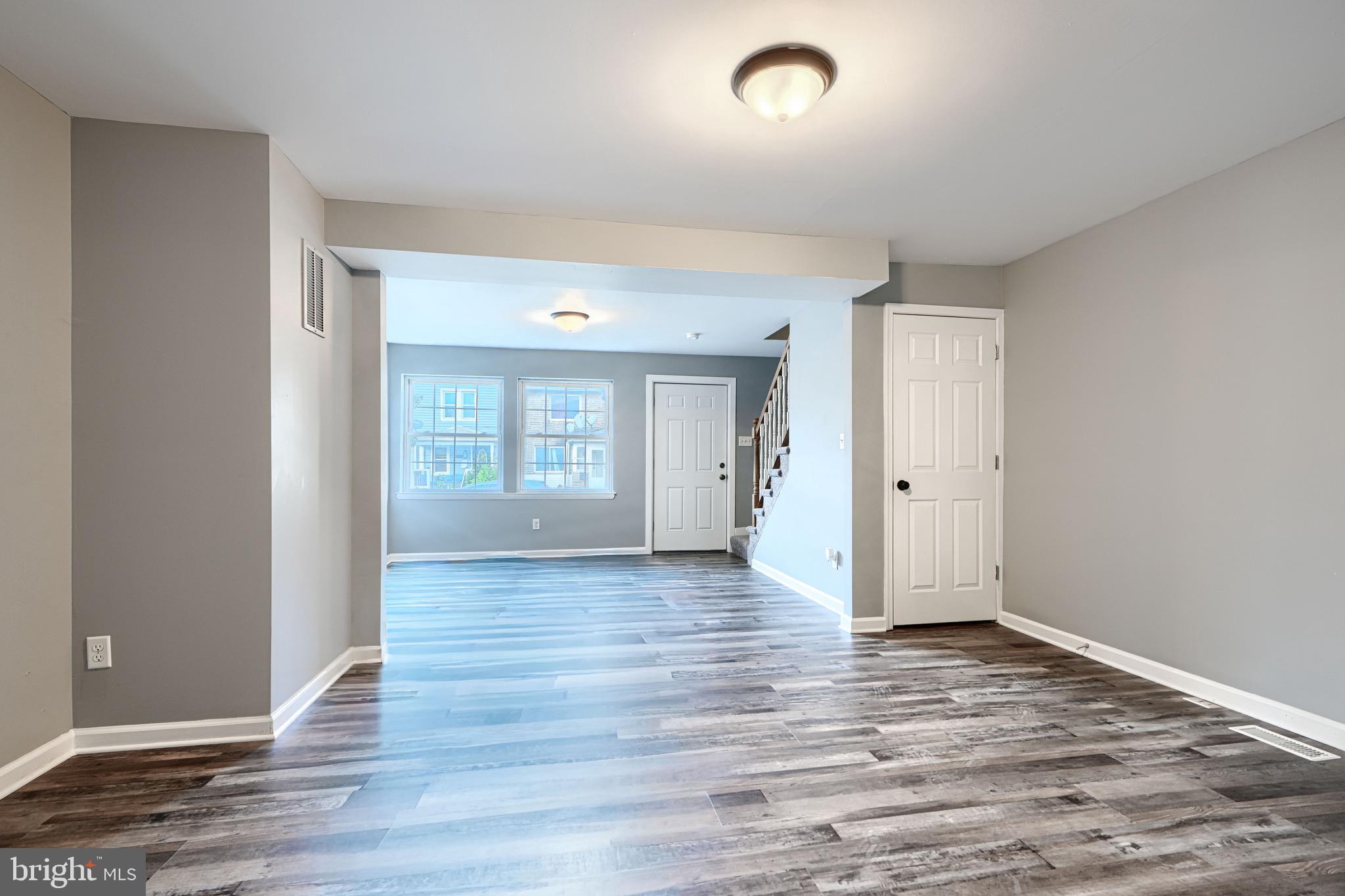 213 Colgate Avenue Baltimore, MD 21222 - Photo 6 of 24 a view of an empty room with window and wooden floor