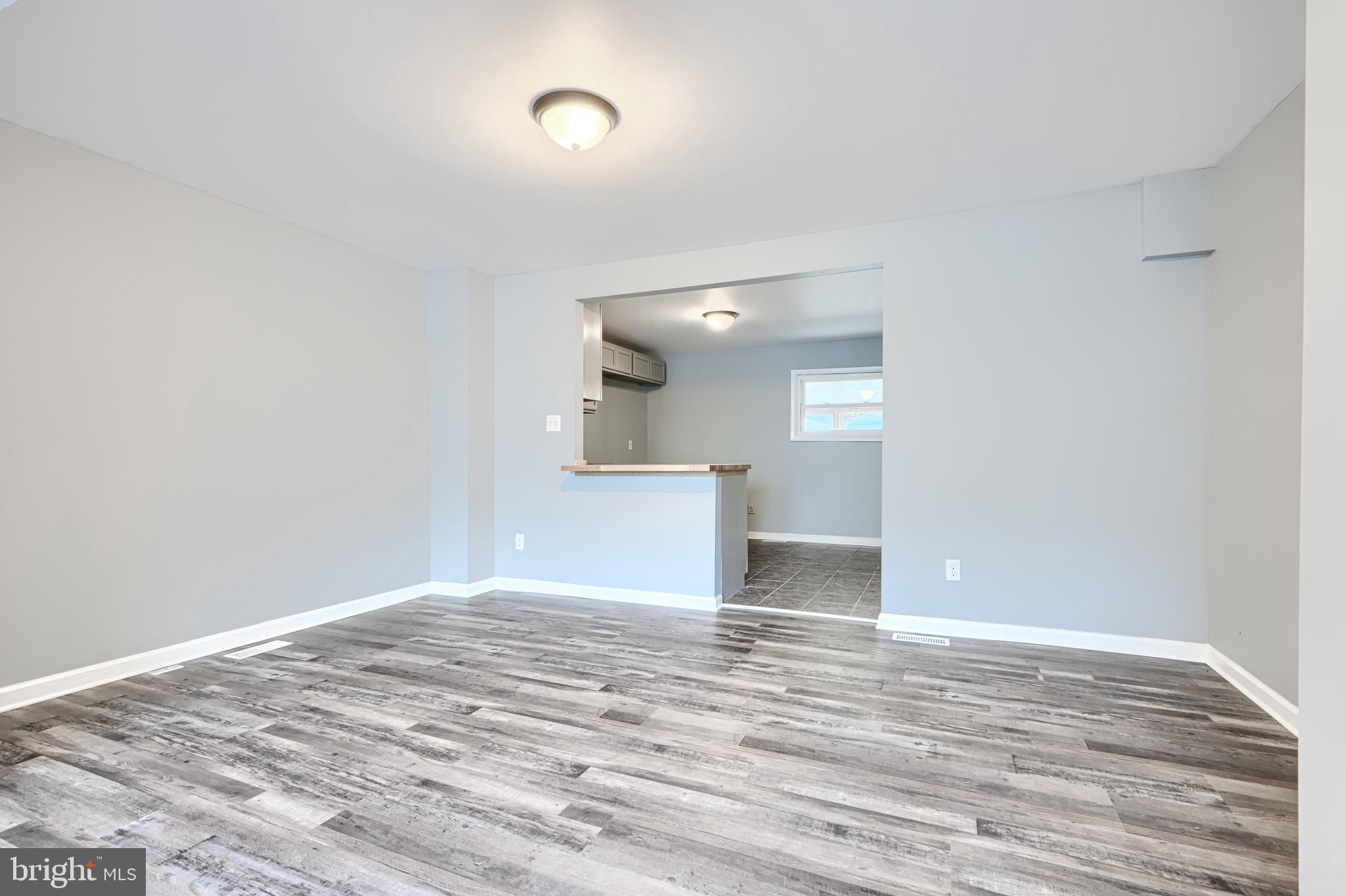 213 Colgate Avenue Baltimore, MD 21222 - Photo 7 of 24 a view of empty room with wooden floor