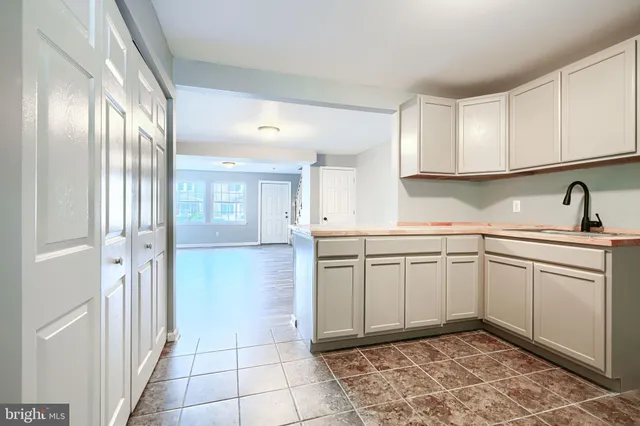 a kitchen with a sink cabinets and appliances