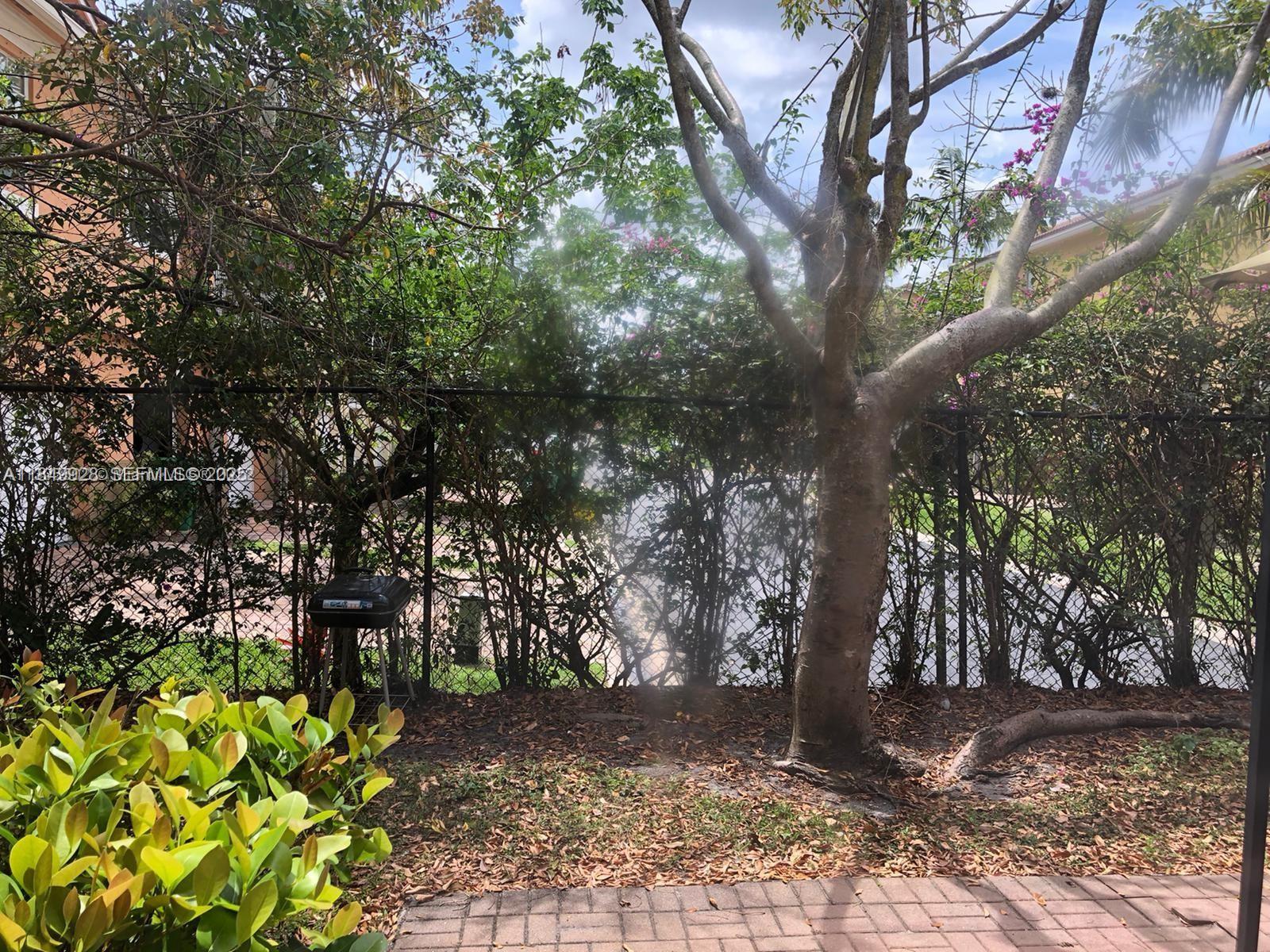 1911 Hibiscus Lane Riviera Beach, FL 33404 - Photo 6 of 8 a backyard of a house with lots of green space