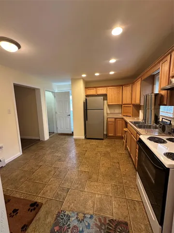 a open kitchen with refrigerator and microwave