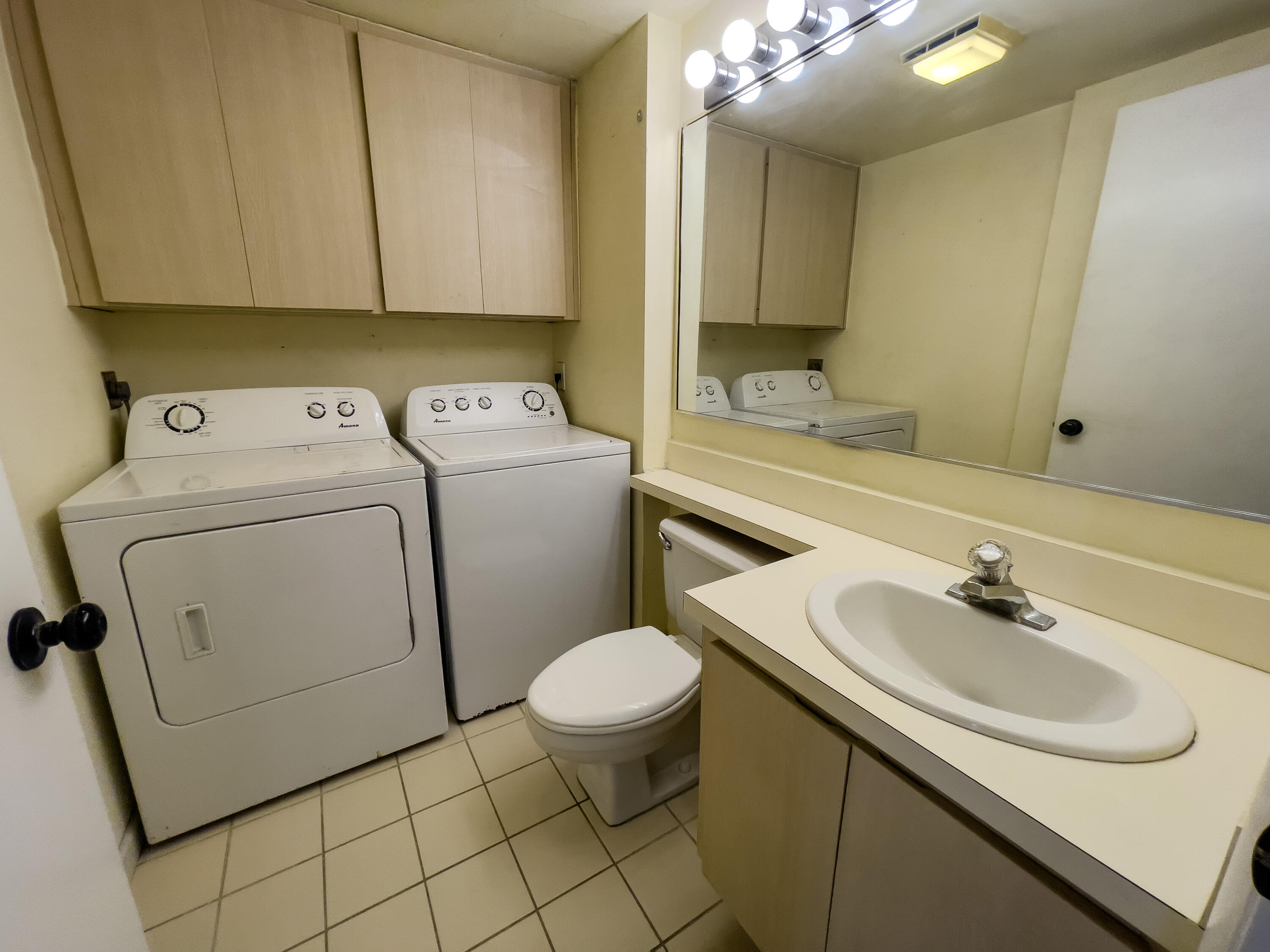 27 Clinton Court, Unit D Royal Palm Beach, FL 33411 - Photo 11 of 32 a bathroom with a sink toilet and a mirror