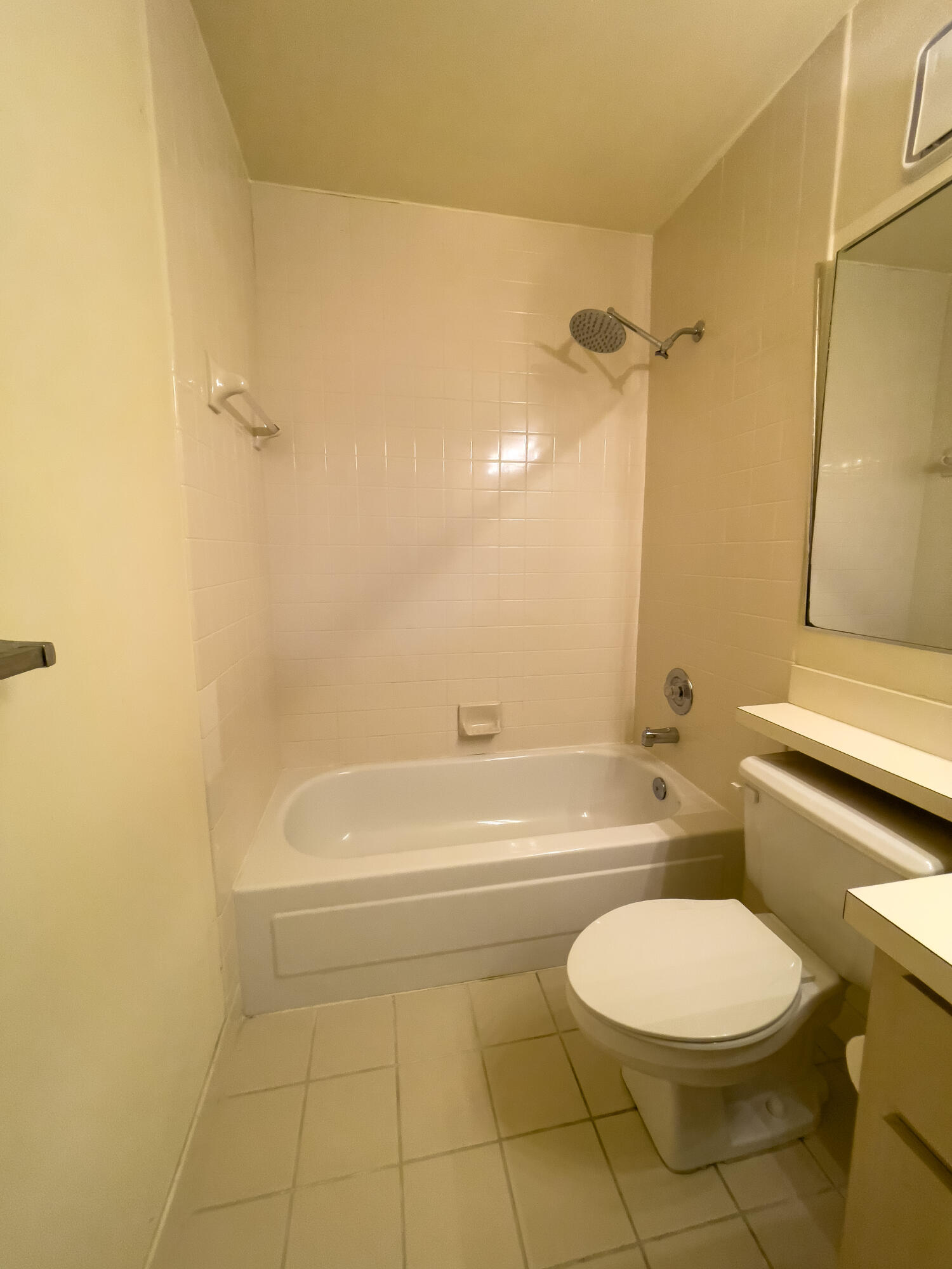 27 Clinton Court, Unit D Royal Palm Beach, FL 33411 - Photo 19 of 32 a bathroom with a toilet a sink and bathtub