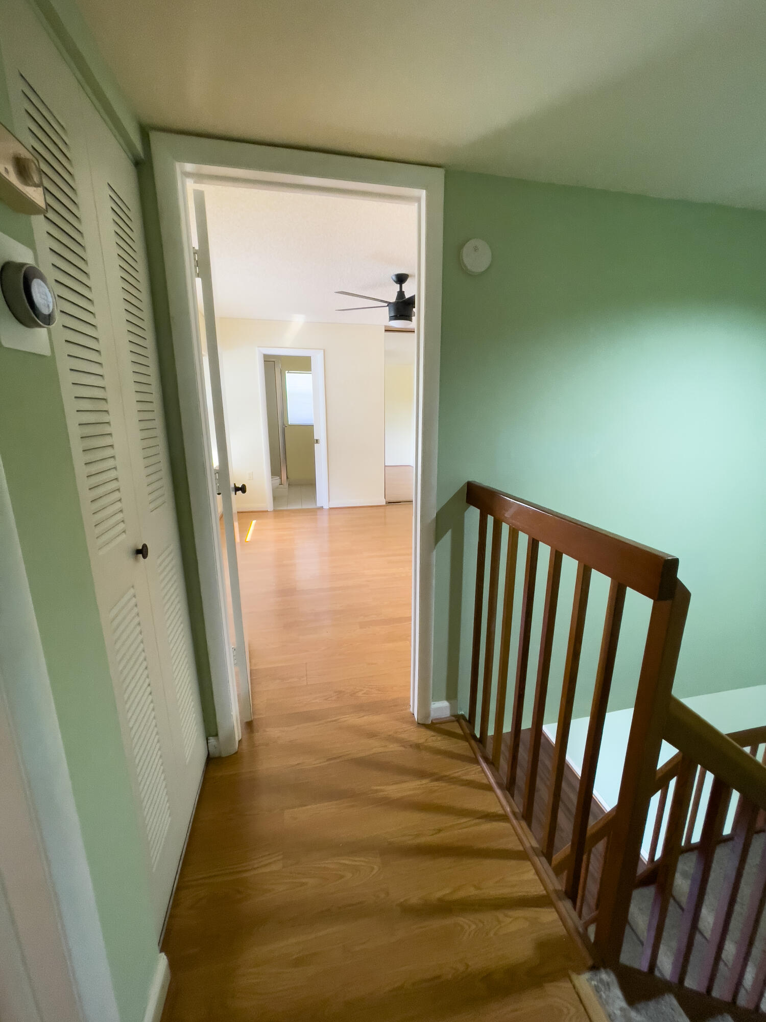 27 Clinton Court, Unit D Royal Palm Beach, FL 33411 - Photo 25 of 32 a view of a hallway with wooden floor and staircase