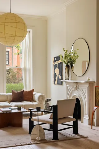 a living room with furniture a fireplace and a table