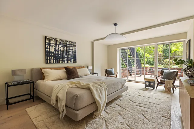 a bedroom with a bed and a large window