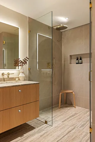a bathroom with a shower sink and mirror