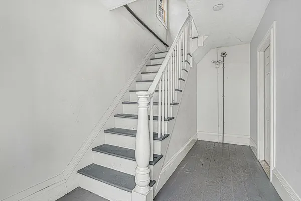 a view of entryway with stairs and wooden floor