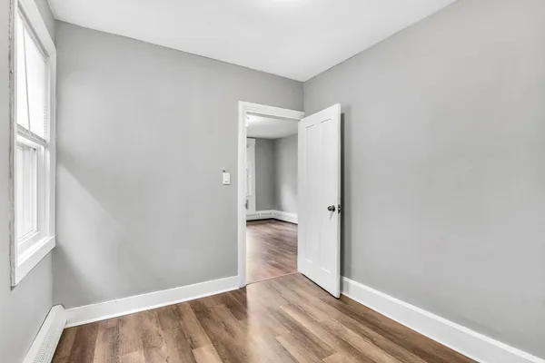a view of hallway with wooden floor